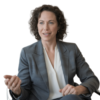 woman sitting at desk talking to another person who is not seen